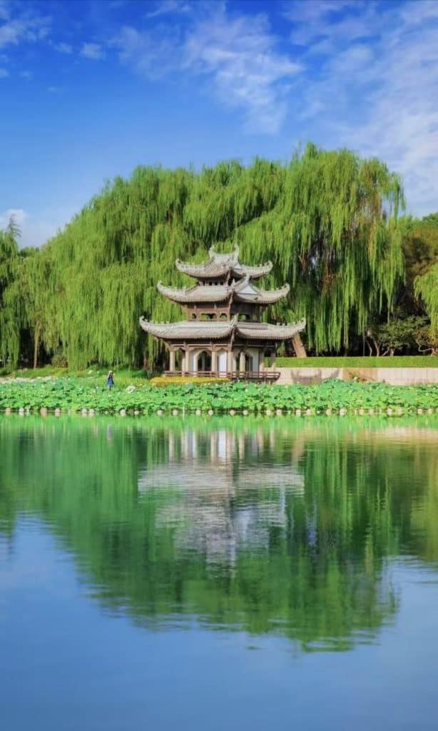 Pavilion reflected on calm water at Taoranting Park, Beijing, China