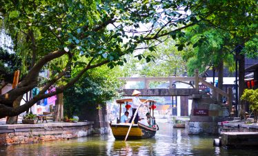 A hand-rowed boat is floating on the canal-Shanghai Zhujiajiao water town