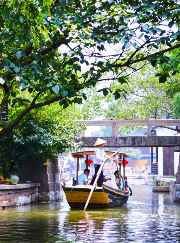 A hand-rowed boat is floating on the canal-Shanghai Zhujiajiao water town