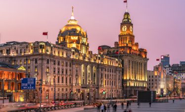 The Bund and the architecture in the former French Concession Area at night, with rush-hour traffic and light trails.