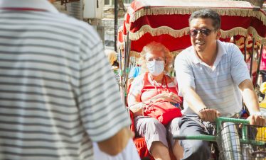A rickshaw is taking a tourist-Beijing