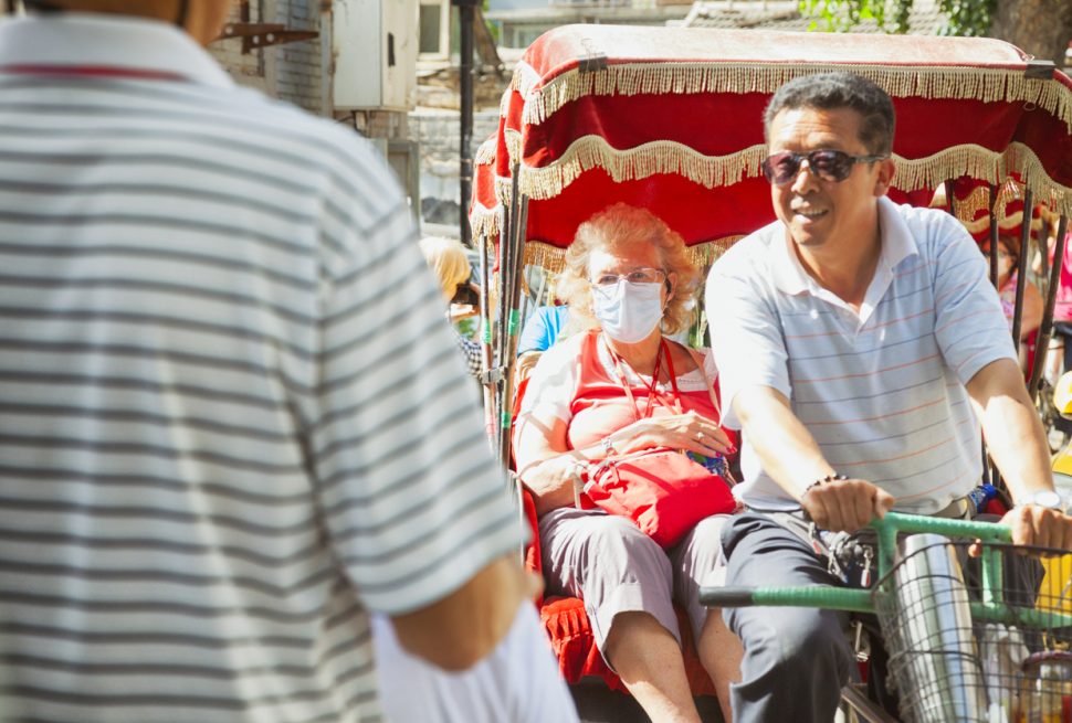 A rickshaw is taking a tourist-Beijing