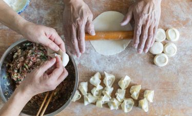 Tourist making wontons with local Shanghai family at home