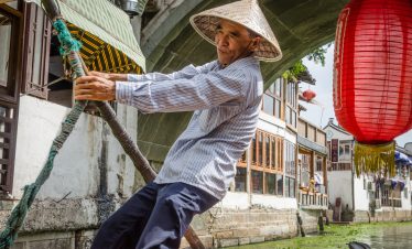 A boatman is rowing a boat in Zhujiajiao water town, China