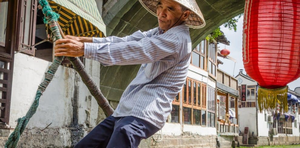 A boatman is rowing a boat in Zhujiajiao water town, China