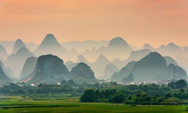 Guilin, China karst mountain landscape at dusk.