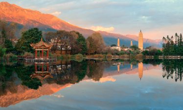 Chongsheng Three Pagodas at sunset with Erhai Lake in the foreground in Dali, Yunnan