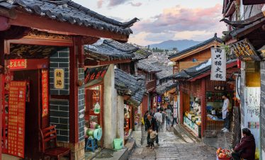 Alley in Yunnan Lijiang Old Town with distant view of Jade Dragon Snow Mountain
