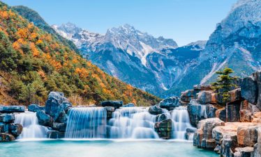 Waterfall cascading into Blue Moon Valley at Jade Dragon Snow Mountain, Lijiang, Yunnan