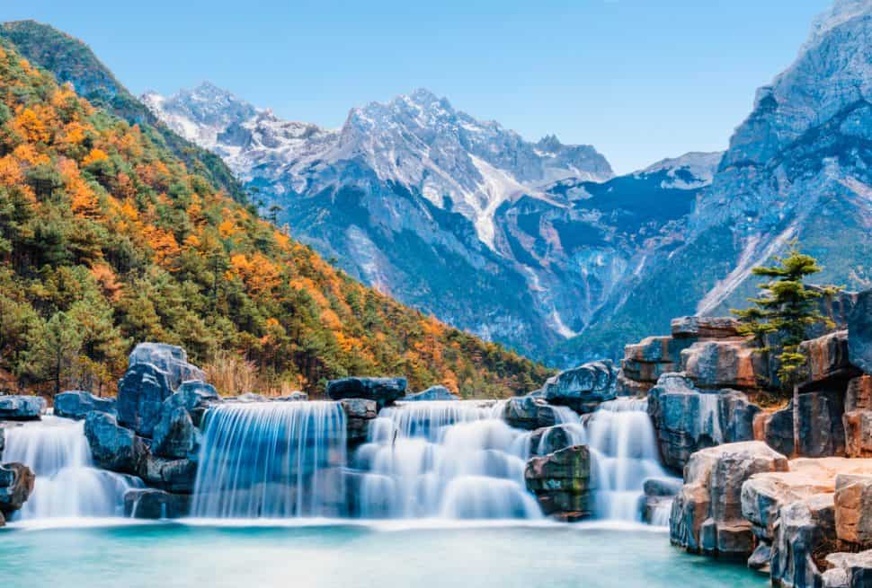 Waterfall cascading into Blue Moon Valley at Jade Dragon Snow Mountain, Lijiang, Yunnan