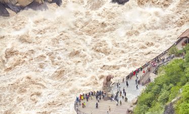 Aerial view of roaring Jinsha River with tiger statue at Tiger Leaping Gorge, Shangri-La, Yunnan