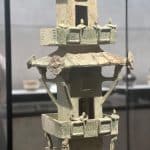 A detailed tower-shaped artifact in the Shanghai Museum, China, with intricately crafted tiny figures.