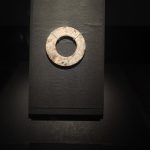 A jade disk unearthed from Sanxingdui, Sichuan, China, showcasing ancient craftsmanship.