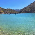 A tranquil scene at Blue Moon Valley, Yunnan, China, with a calm lake and wide-open valley.