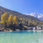 The crystal-clear waters of Blue Moon Valley, Yunnan, China, glowing with a vibrant blue hue.
