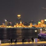 The dazzling golden lights illuminating the Bund in Shanghai, China, at night.