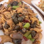 A plate of stir-fried snails, a popular delicacy in Guangxi, China.