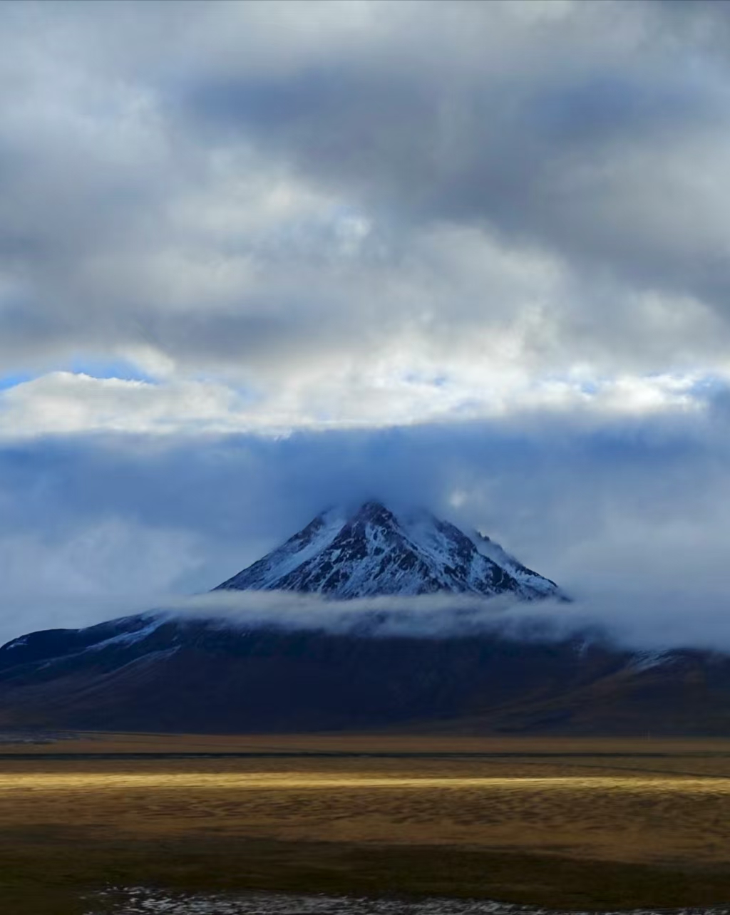 Snowy mountains shrouded in mist in Saga Tibet