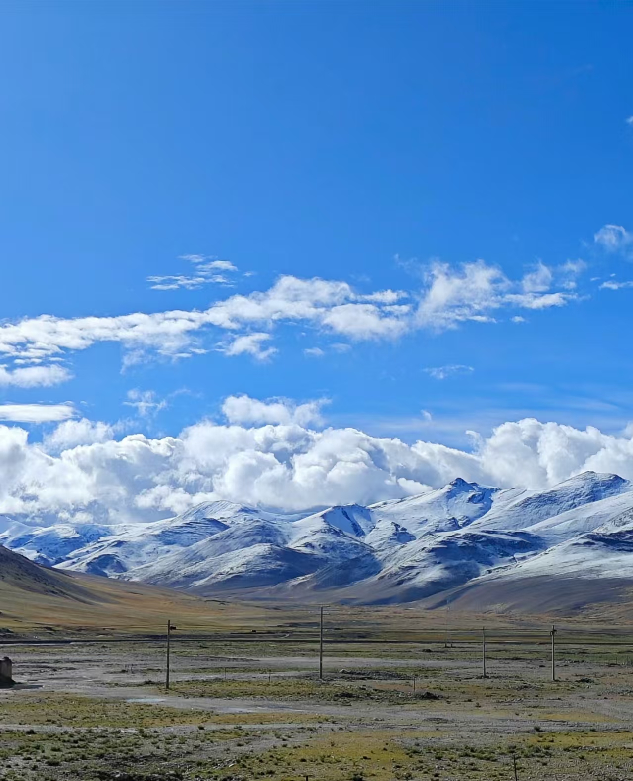 Snowy mountains in Saga Tibet under clear blue sky