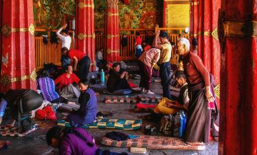 Devotee praying inside Jokhang Temple in Tibet