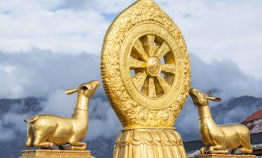 Golden roof of Jokhang Temple with deer and Dharma wheel in Tibet