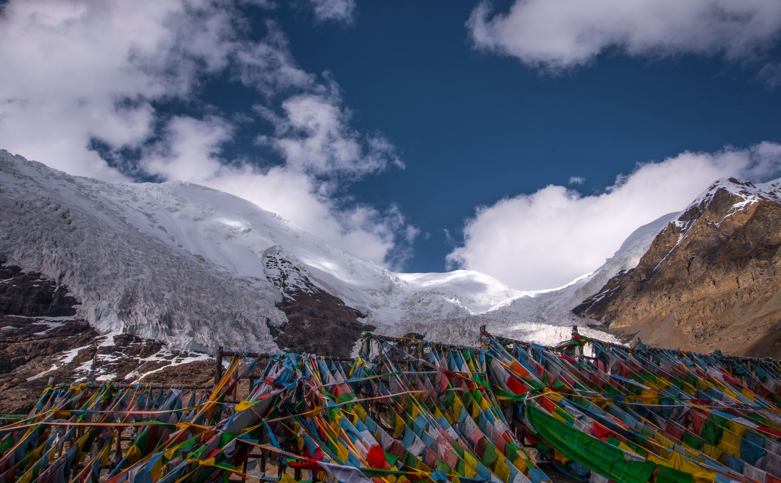 Colorful prayer flags flying at Karola Glacier in Tibet