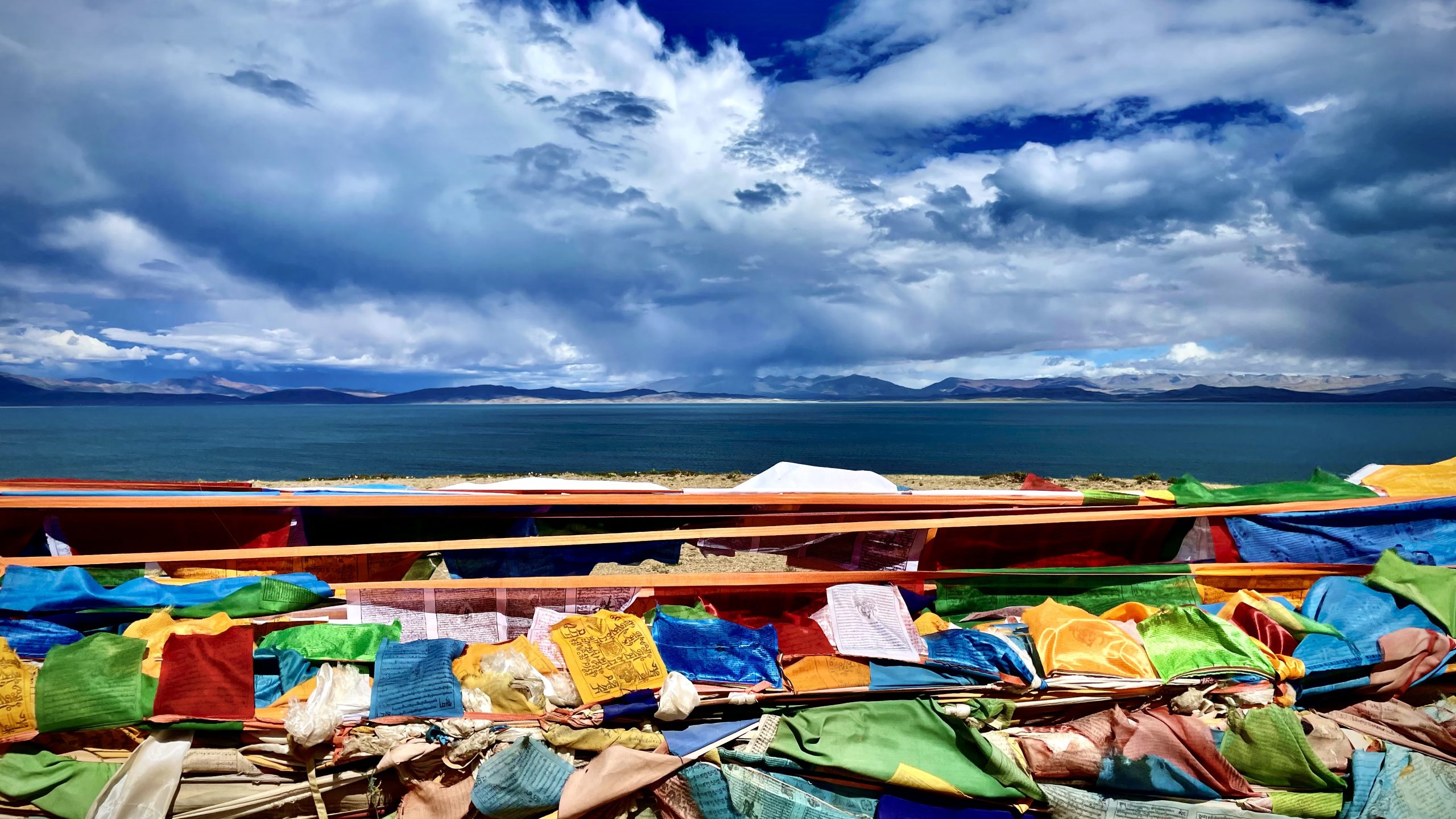 Colorful prayer flags in front of Lake Manasarovar in Tibet
