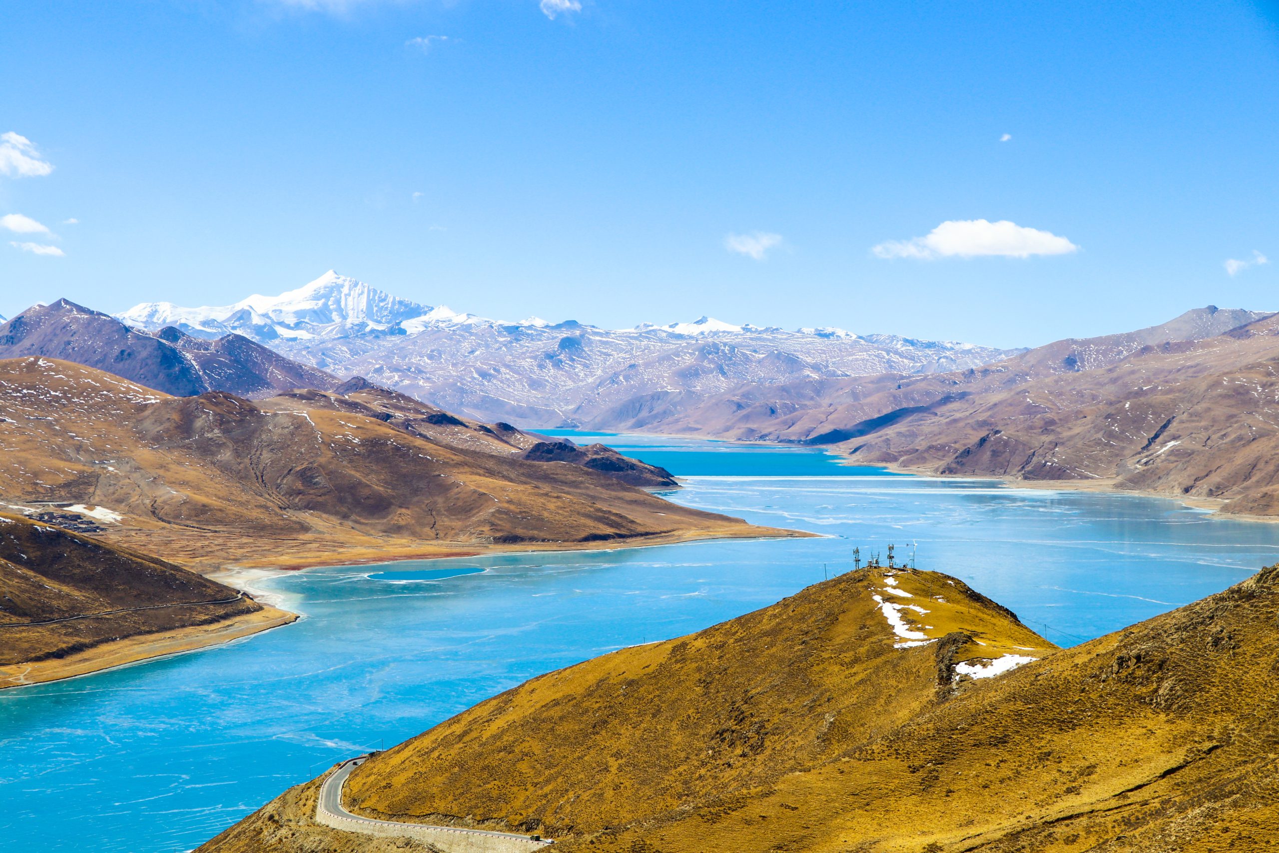 Distant view of Yamdrok Lake surrounded by mountains in Tibet
