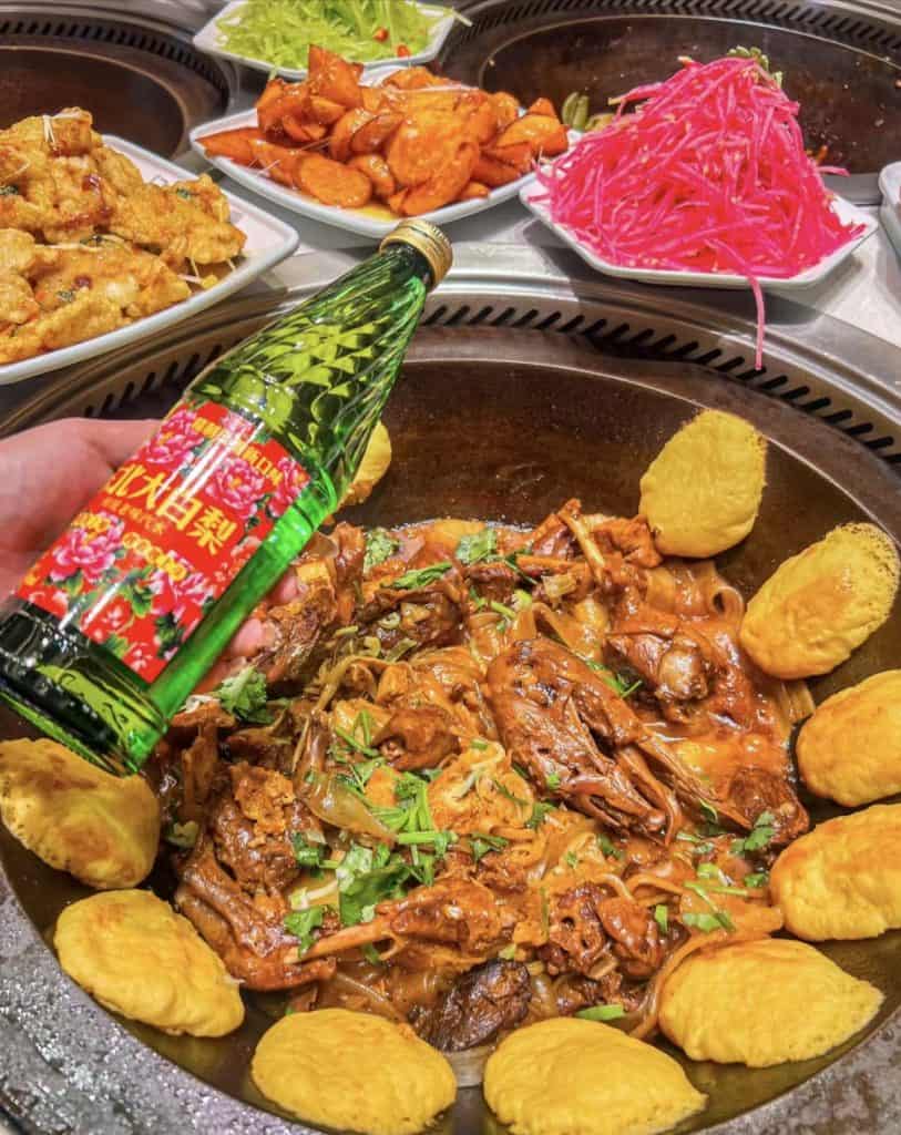 Tourists enjoying hot Northeast-style stew at Harbin Ice and Snow Festival, China